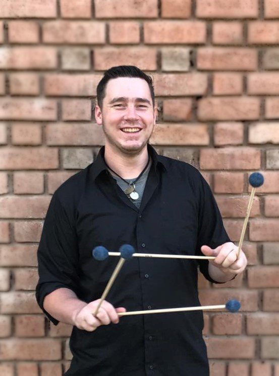 Tyler J. Haley Headshot Brick wall.jpg